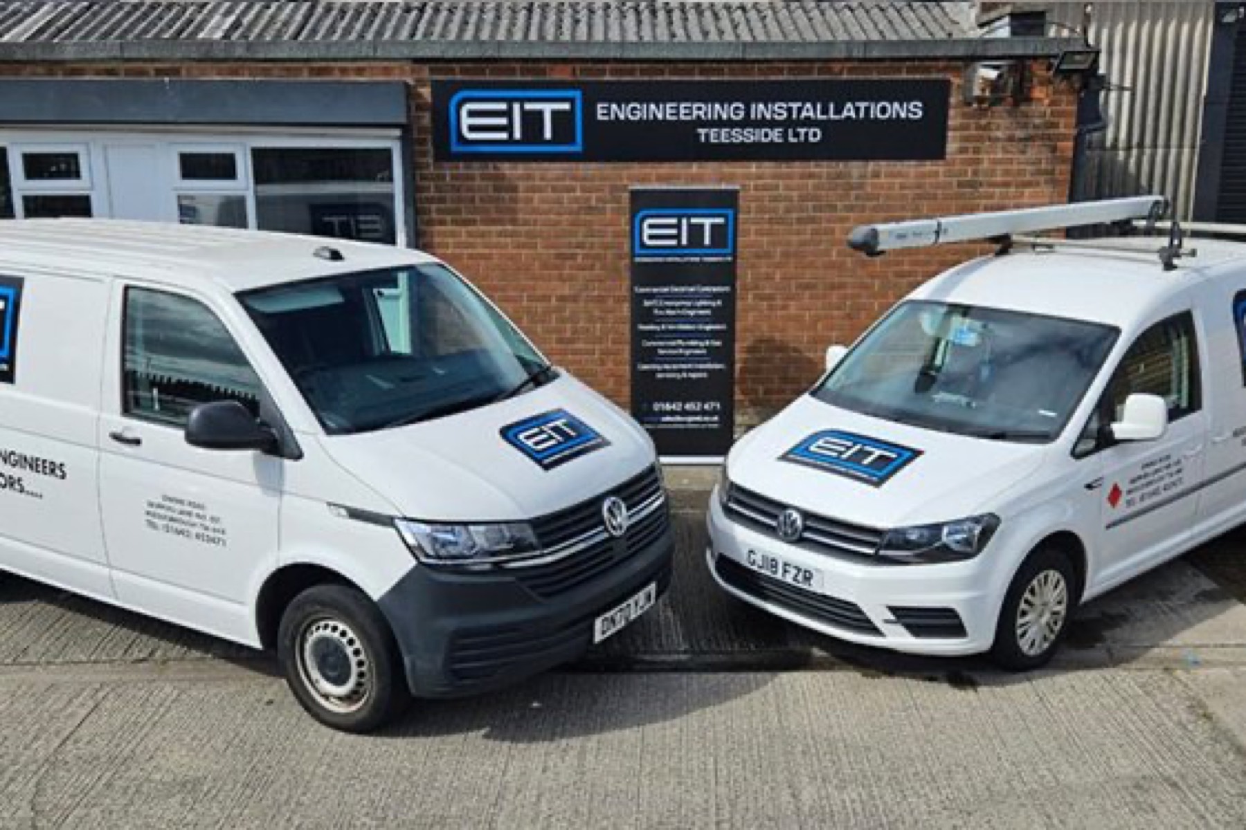 EIT engineers and liveried vans
